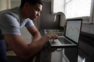 Man looking at investments. 