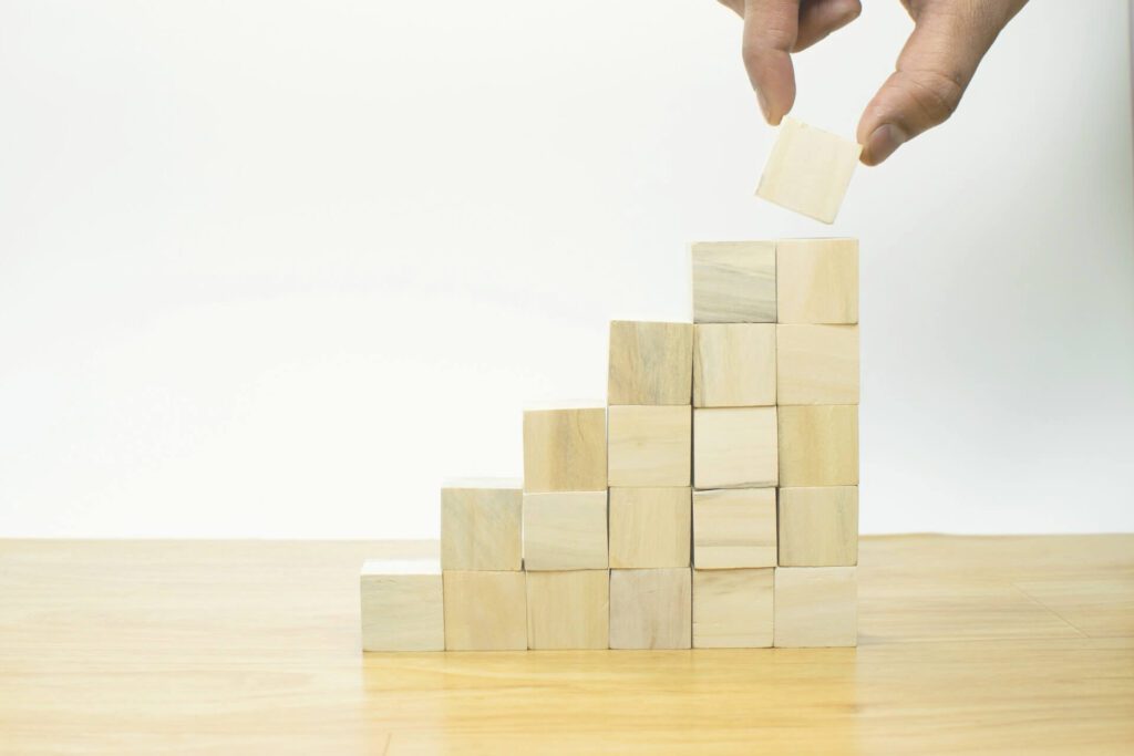 Blocks graphic showing the best investments in your 20s beyond money like health, skills, relationships, travel, and projects.